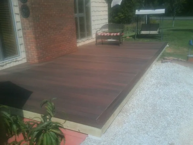 Freshly stained wood deck built against a brick home in Snowmass